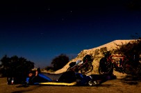 Reading and sleeping on a tarpaulin under the desert stars. The moon was so bright we almost had no need for torches. NW Gansu Province, China.